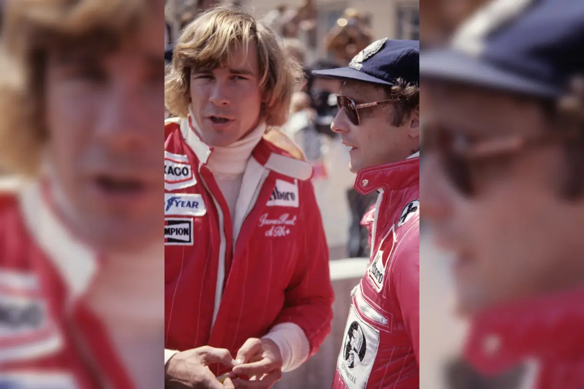 Two race car drivers in red suits.