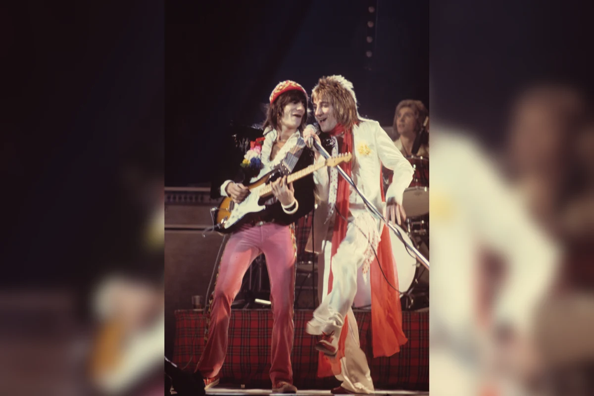 Musicians performing energetically on stage together.